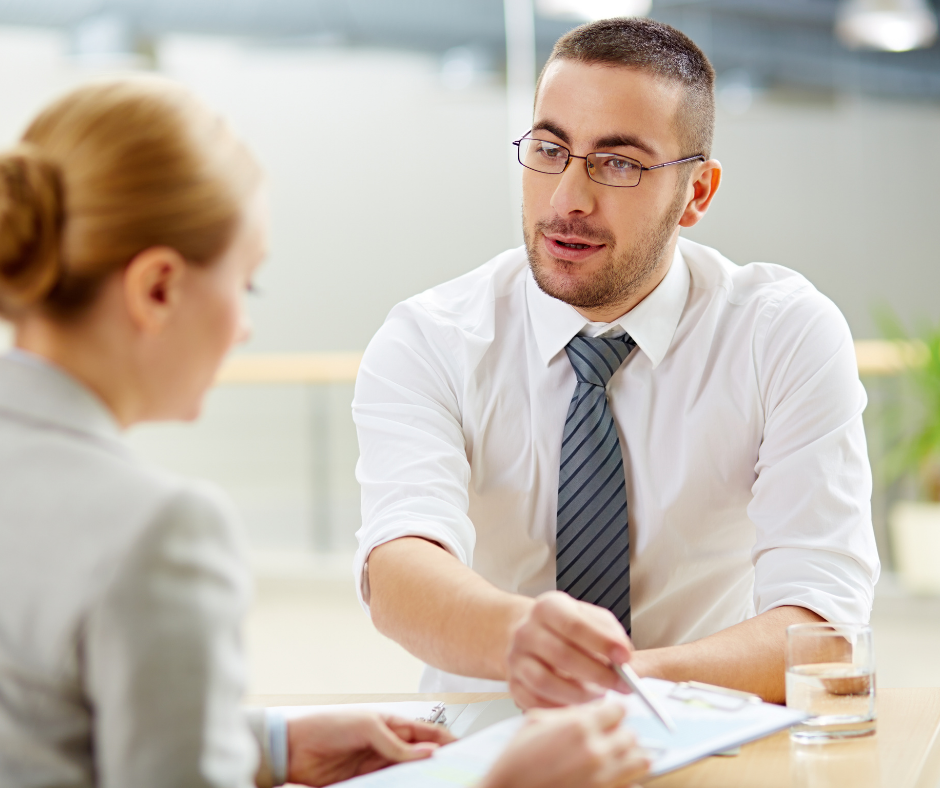 A man in a business shows people how to make content clear with plain language editing