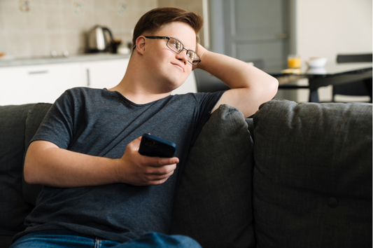 A young man with intellectual disability looks at accessible content on a phone