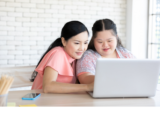 Two women looking at HTML Easy Read pages in a computer screen together